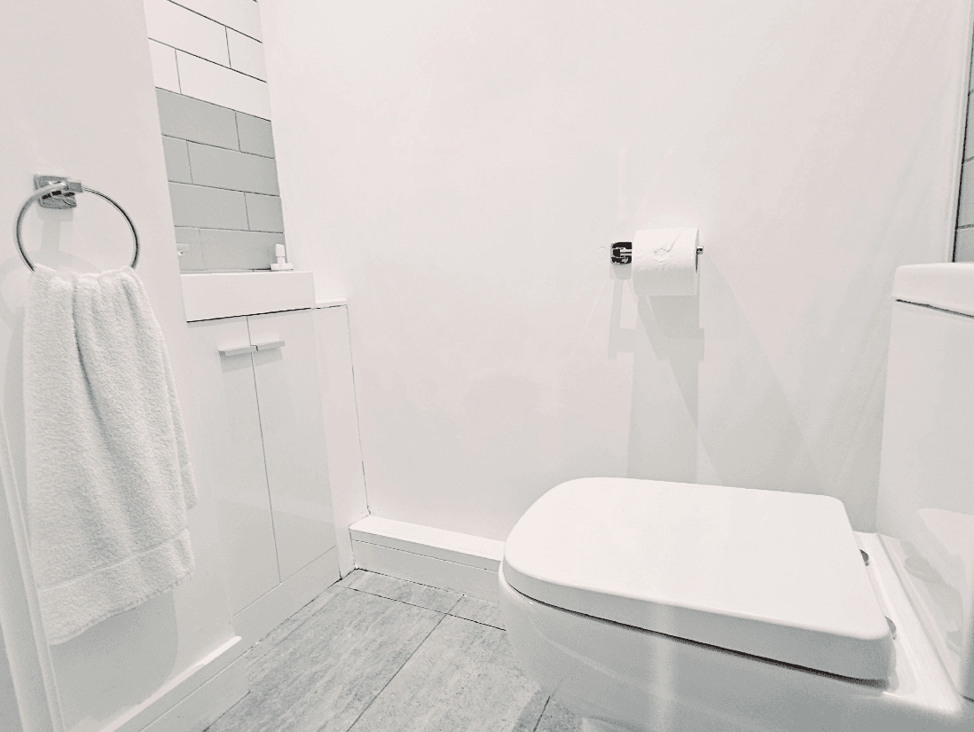 Modern bathroom with overhead shower and white tiling at The Maple Suite, Oakdale Apartments, Farnham Modern bathroom with overhead shower and white tiling at The Maple Suite, Oakdale Apartments, Farnham