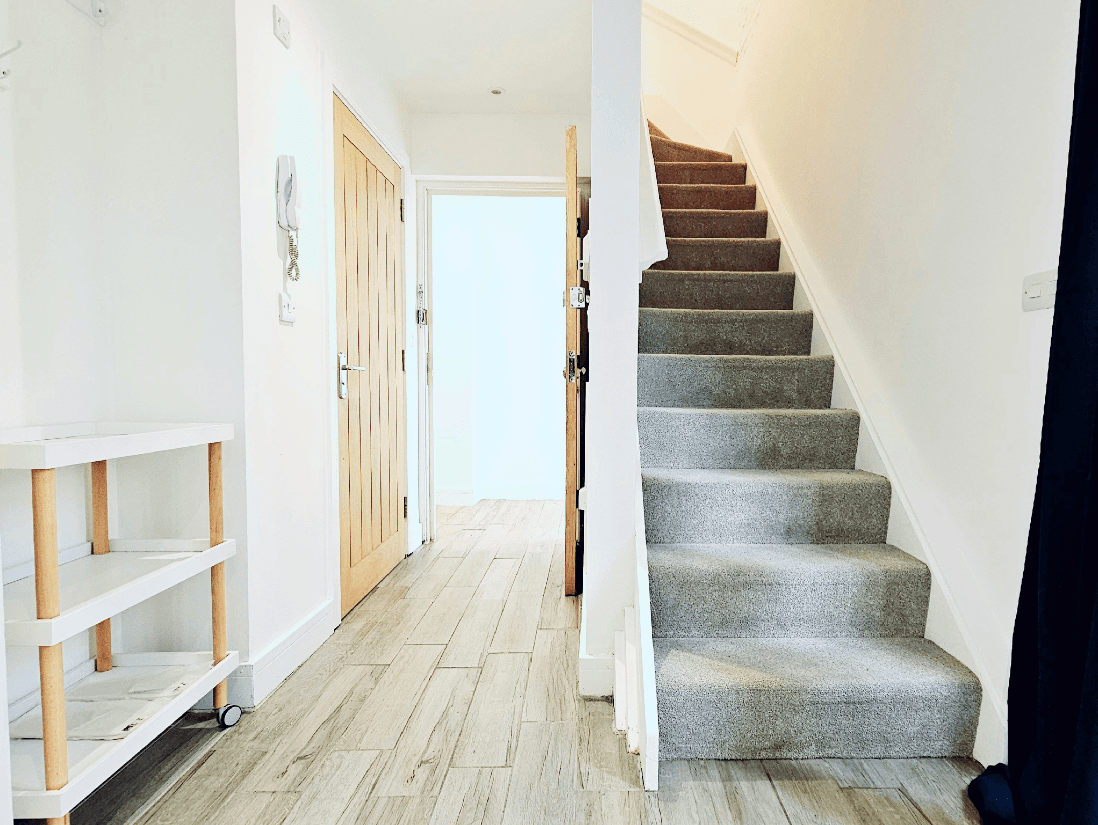 Bright entryway with carpeted staircase and wood flooring in The Maple Suite, Farnham Bright entryway with carpeted staircase and wood flooring in The Maple Suite, Farnham
