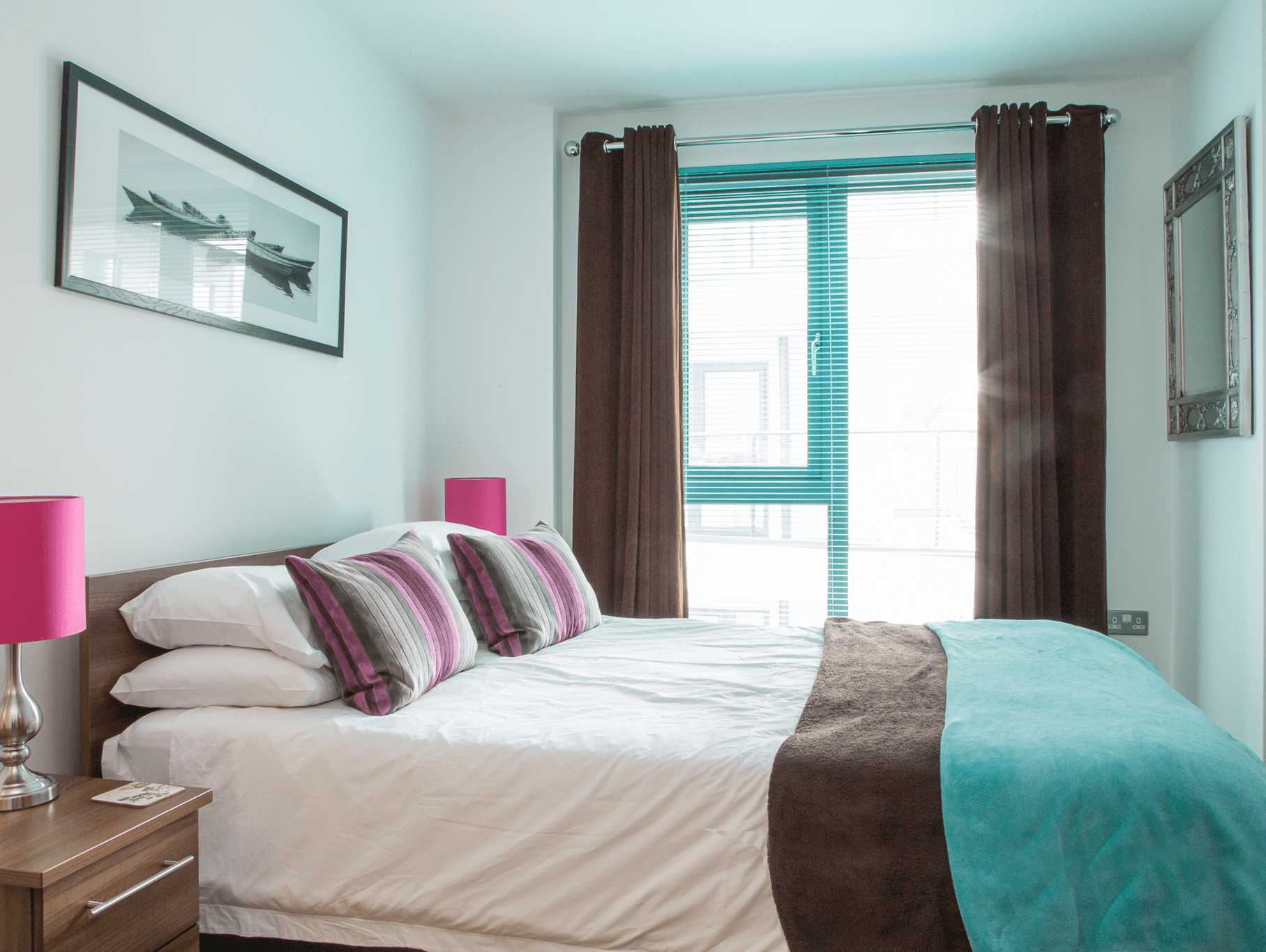 Bright double bedroom with pink cushions, artwork, and modern window at The Willow Suite, Cardinal Place, Woking Bright double bedroom with pink cushions, artwork, and modern window at The Willow Suite, Cardinal Place, Woking