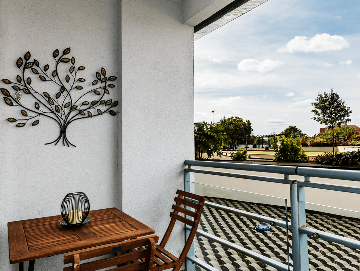 Private outdoor balcony with decorative wall art and bistro table set at The Amber Suite, Woking Private outdoor balcony with decorative wall art and bistro table set at The Amber Suite, Woking