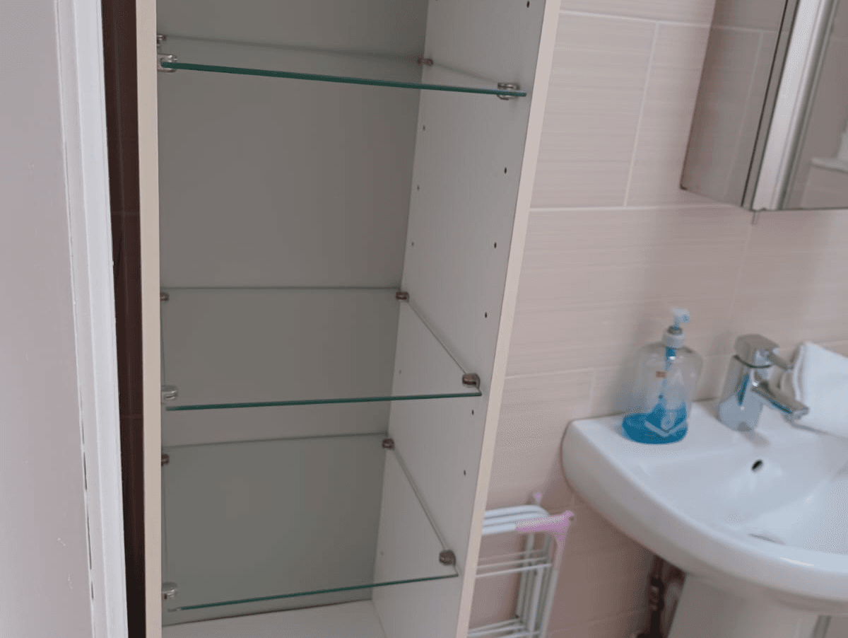 Glass-shelved bathroom cabinet with toiletries in clean white bathroom – Castle 16 - Southampton Glass-shelved bathroom cabinet with toiletries in clean white bathroom – Castle 16 - Southampton