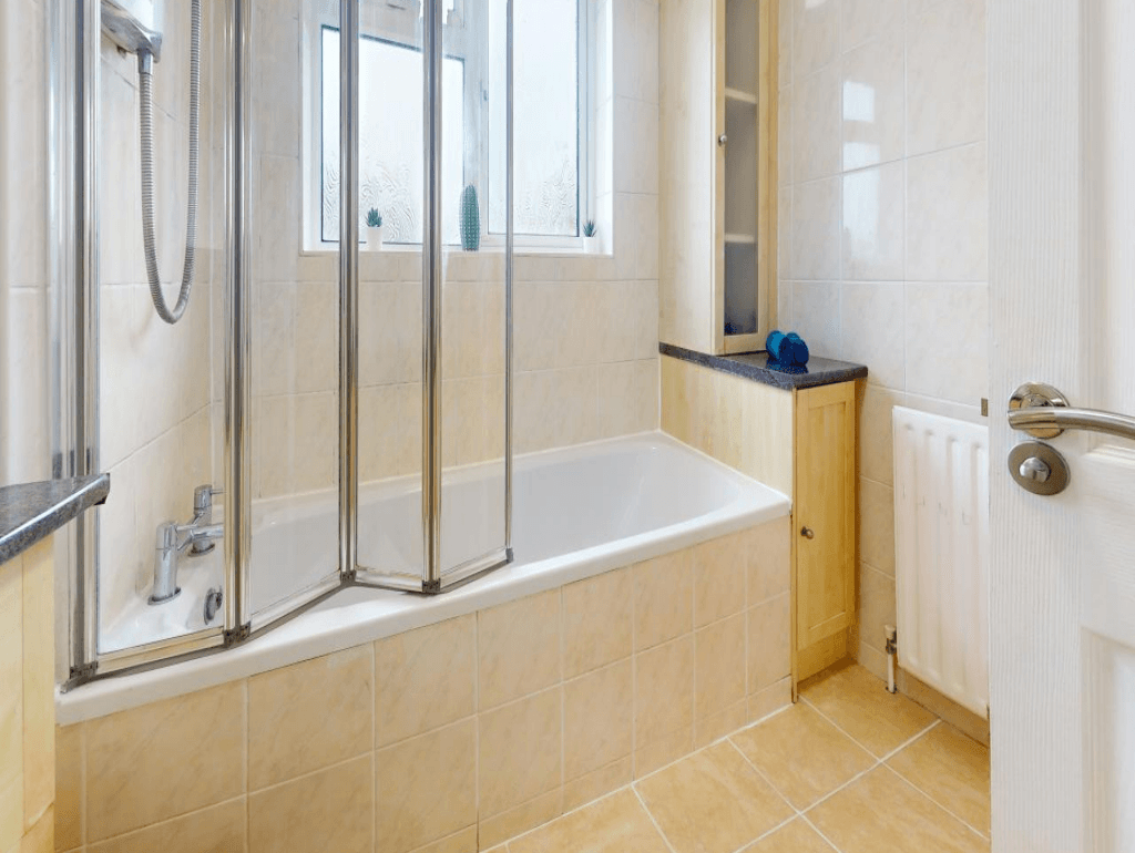Bathroom with white tiles, glass shower enclosure, and full-size bathtub by window – Parlaunt House - Slough Bathroom with white tiles, glass shower enclosure, and full-size bathtub by window – Parlaunt House - Slough