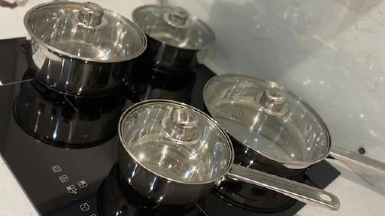 Stovetop with three stainless steel pans in modern kitchen – De Parys Flat 2, Bedford Stovetop with three stainless steel pans in modern kitchen – De Parys Flat 2, Bedford