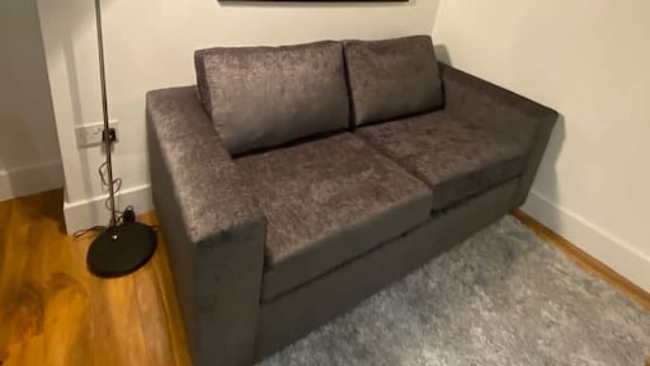 Contemporary grey sofa, floor lamp, and plush rug in living room corner – De Parys Flat 4, Bedford Contemporary grey sofa, floor lamp, and plush rug in living room corner – De Parys Flat 4, Bedford