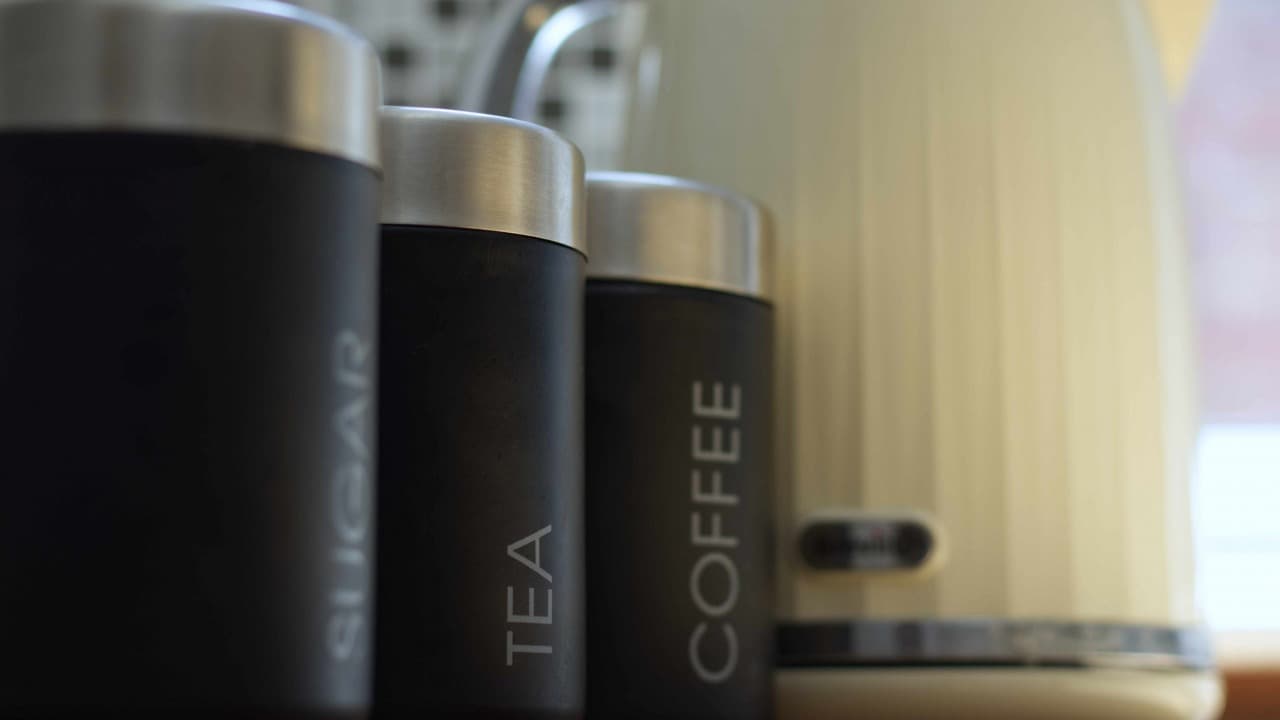 Set of three silver tea, coffee, and sugar canisters on kitchen counter – Terry Road, Coventry Set of three silver tea, coffee, and sugar canisters on kitchen counter – Terry Road, Coventry