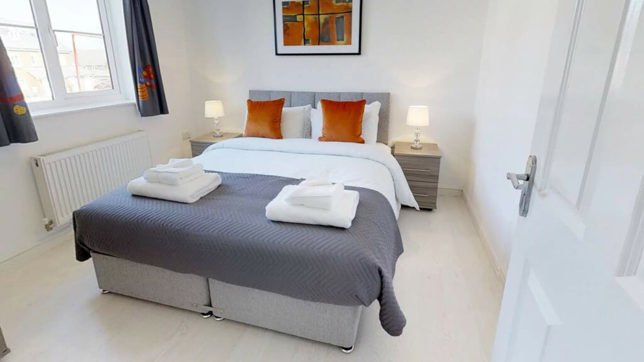 Spacious king bedroom with white bedding, charcoal and red accent pillows, bedside lamps at Cole Green Lane-Herts, Welwyn Garden City Spacious king bedroom with white bedding, charcoal and red accent pillows, bedside lamps at Cole Green Lane-Herts, Welwyn Garden City